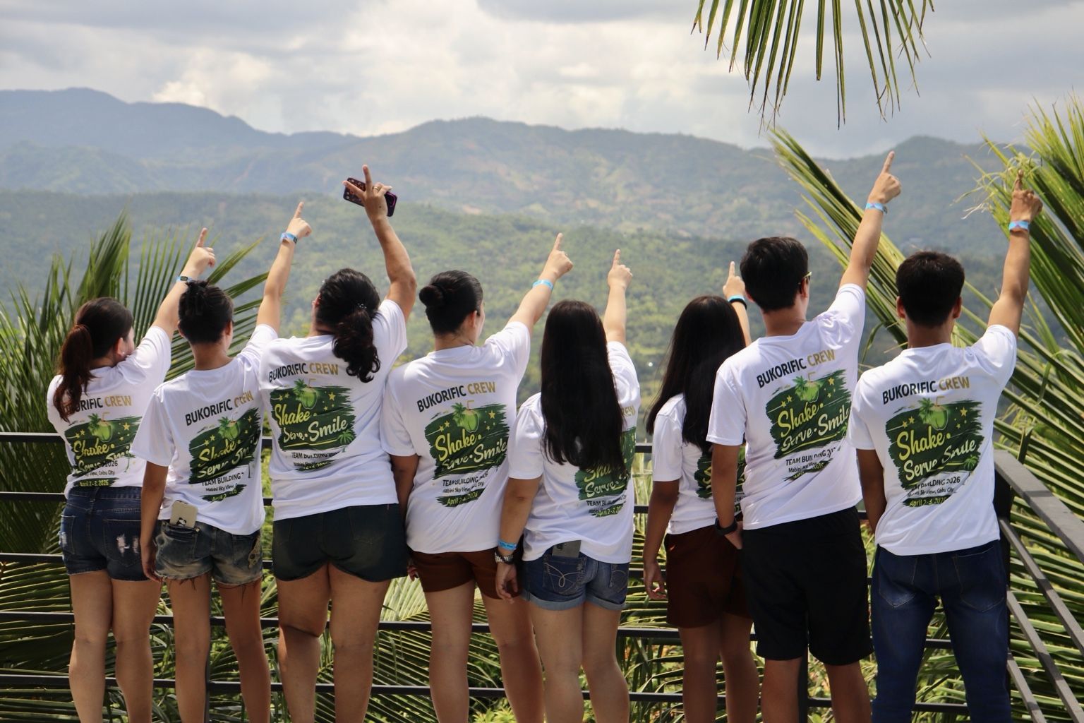 Bukorific crew seen from behind wearing BUKORIFIC CREW – Shake. Serve. Smile. shirts at a Cebu mountain lookout