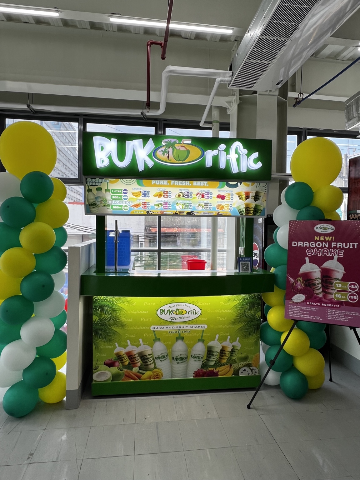 La Nueva Supermarket Magallanes Bukorific kiosk with balloon decorations and Dragon Fruit Shake poster