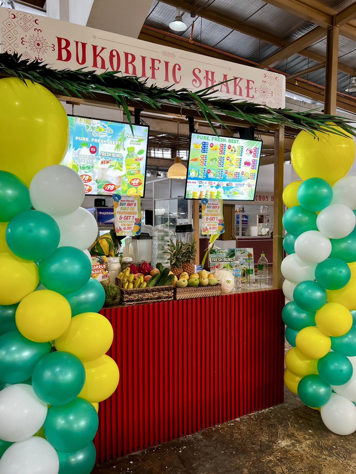 Puso Village Bukorific Shake stall with fruit display and hanging menu boards